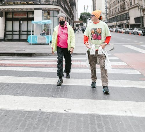 Two pedestrians crossing the road - Carpey Law